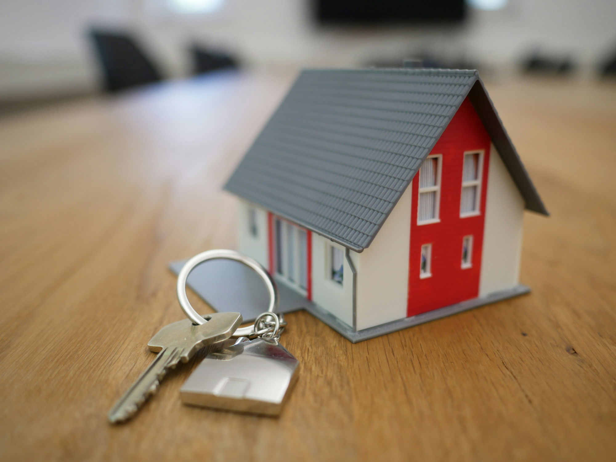 white-and-red-wooden-house-miniature-on-brown-table.jpg white and red wooden house miniature on brown table